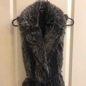 Faux fur sweater vest with belt.